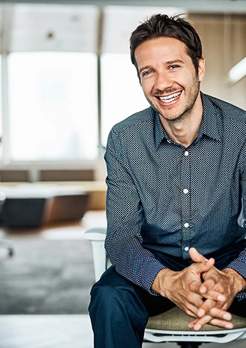a man sitting on the back of a couch