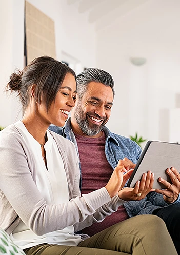 a couple looking at their finances on an ipad