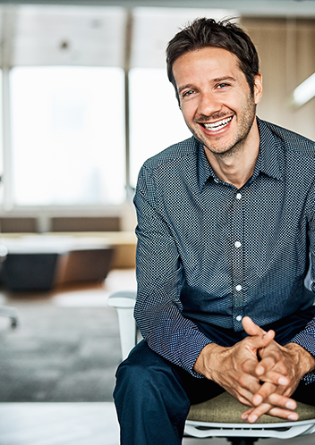 a man sitting on the back of a couch