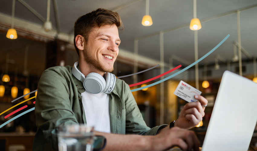 a man wearing headphones and holding a Tech CU credit card