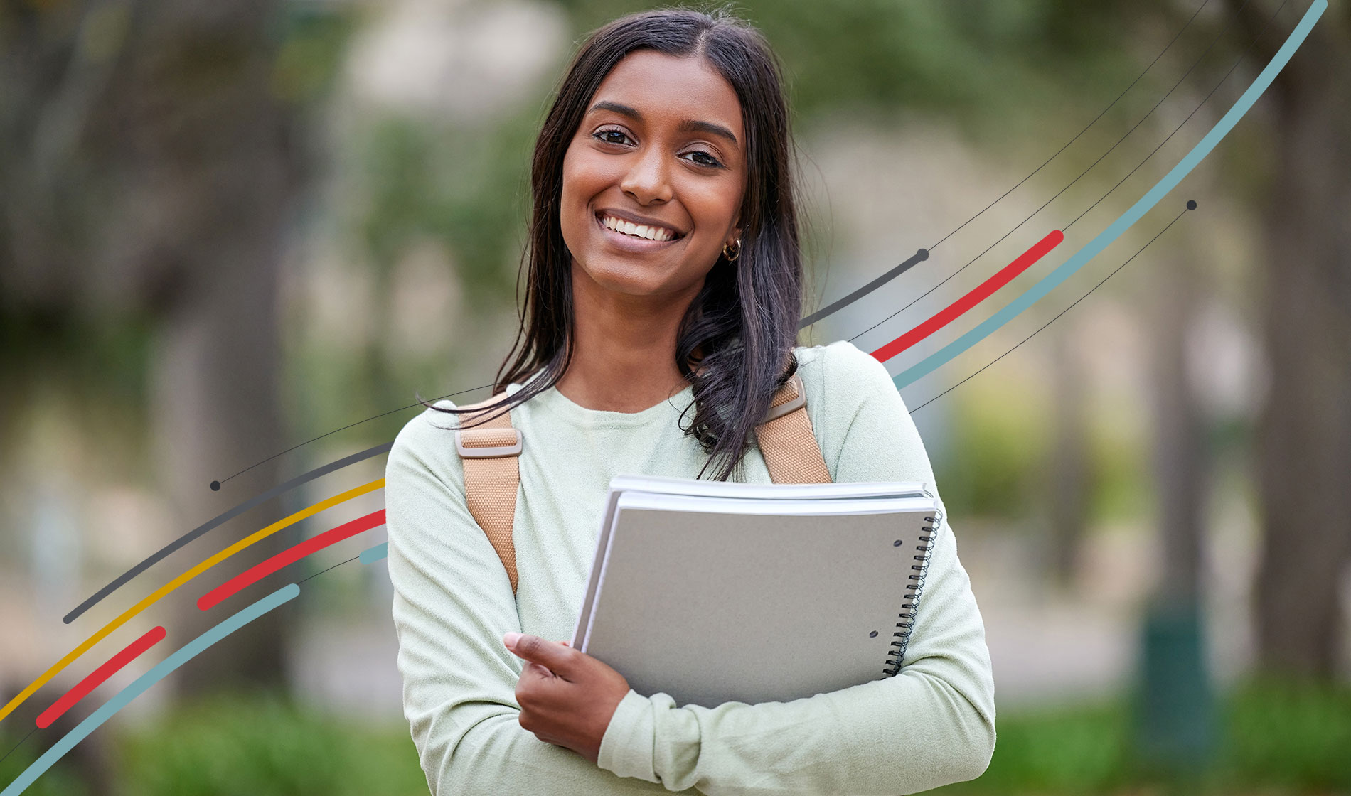 a college student holding notebooks and smiling